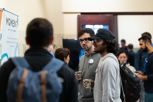 A few people at a sponsor stand