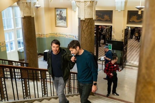 A few people climbing the stairs at the venue