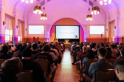 Matz's remote talk playing on the big screen, a view straight down the centre aisle