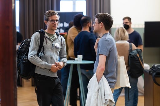 Two men having a dsicussion in the foyer