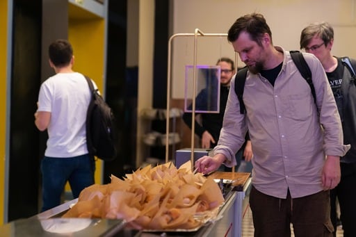 A man picking a coffee pastry