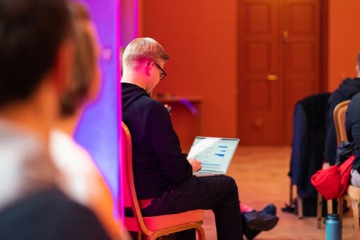 Matias Korhonen takes care of business on his computer during a talk