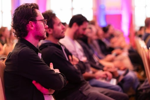 Audience photo down a row of seats, background blurred